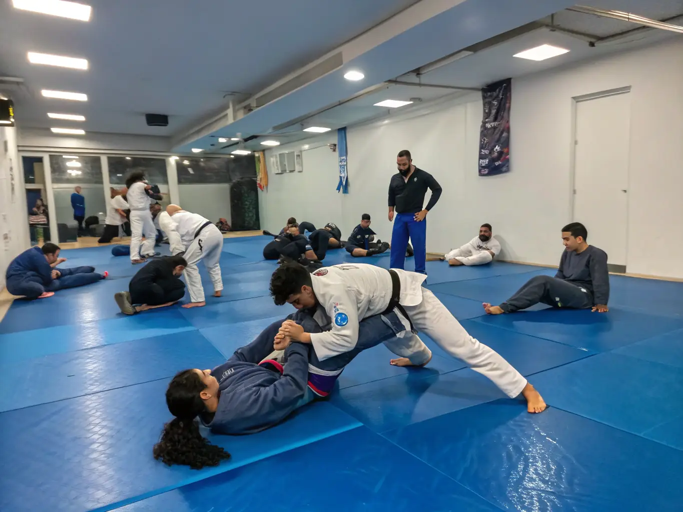 A group of CARBON BJJ students practicing a grappling technique during a class, showcasing the hands-on learning environment.