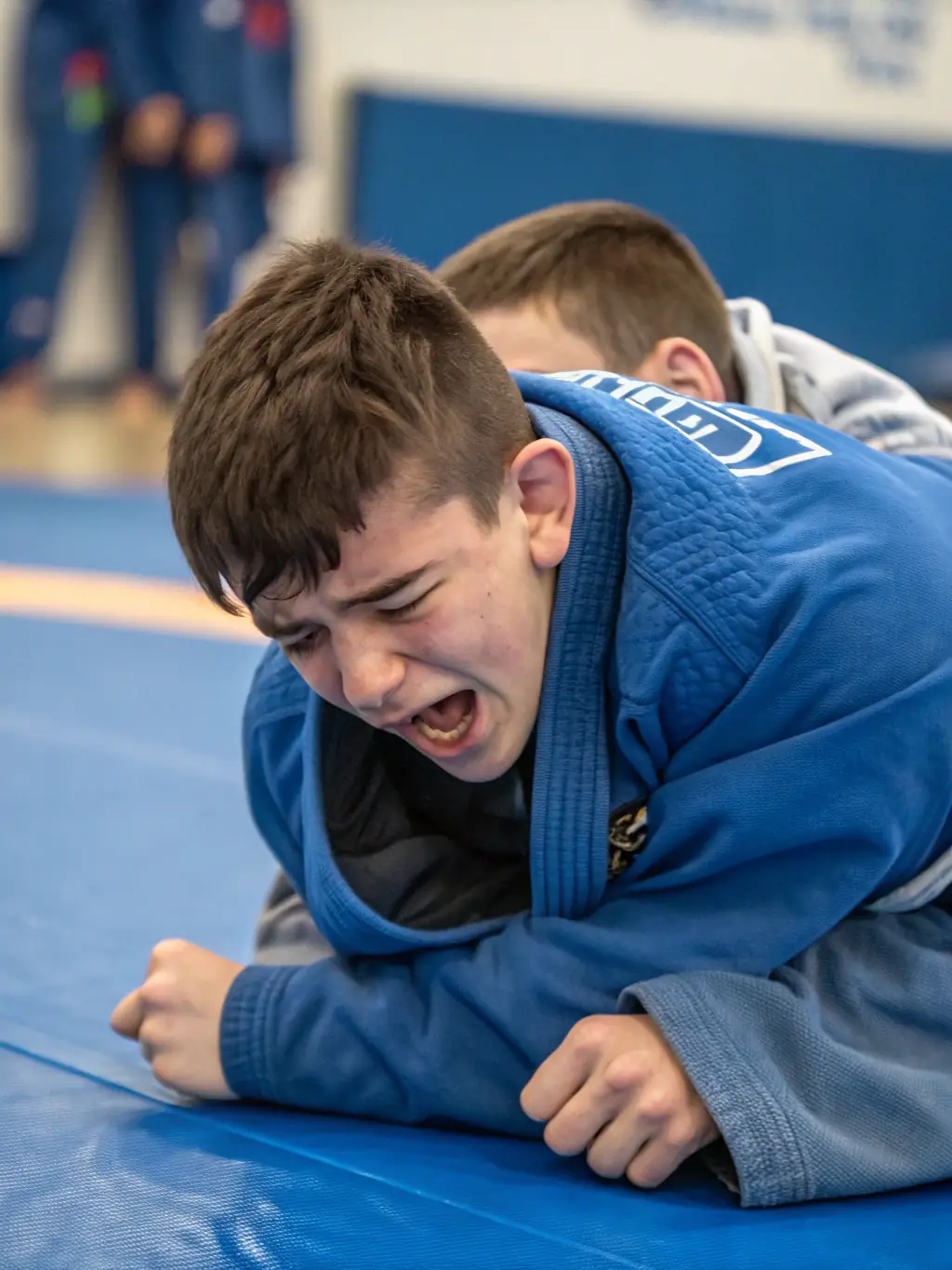 A CARBON BJJ student successfully executing a submission hold during a sparring session, showcasing skill development.